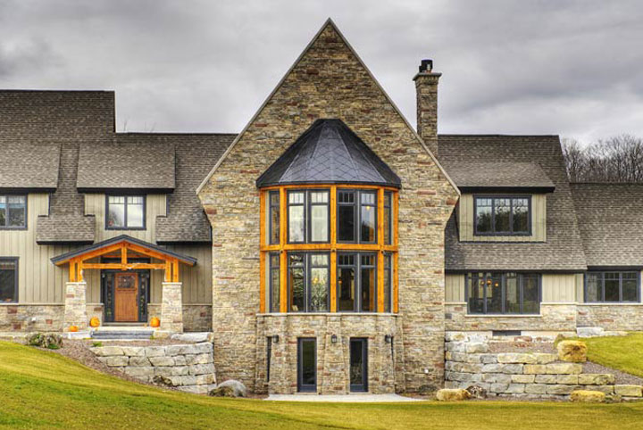 A large tan mansion with stonework