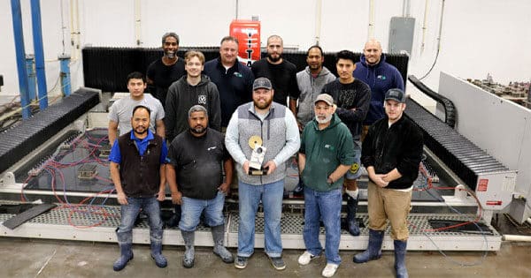 A team of men standing in front of a Park Industries Titan machine